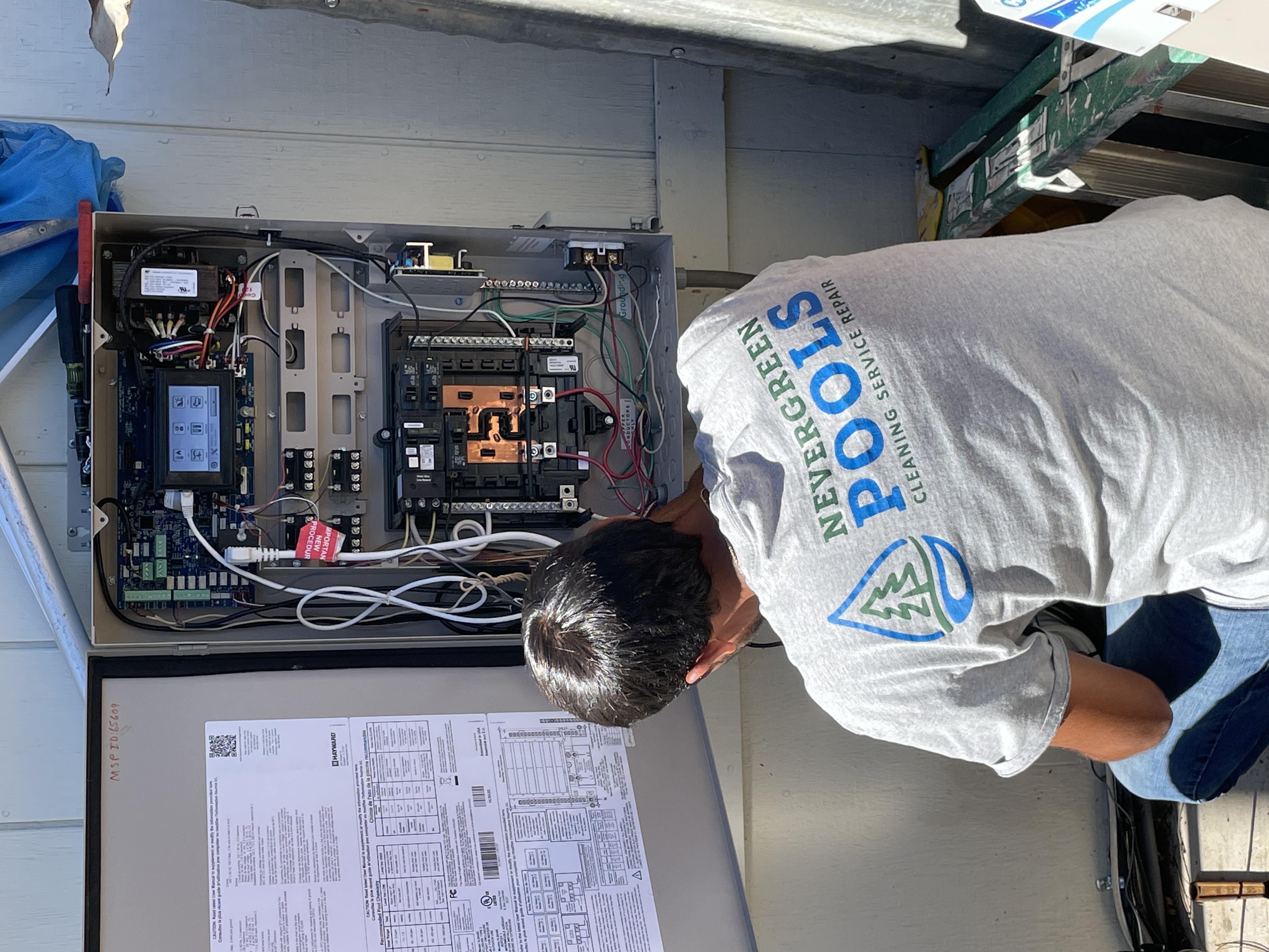 Woody's Pools tech inspecting pool equipment