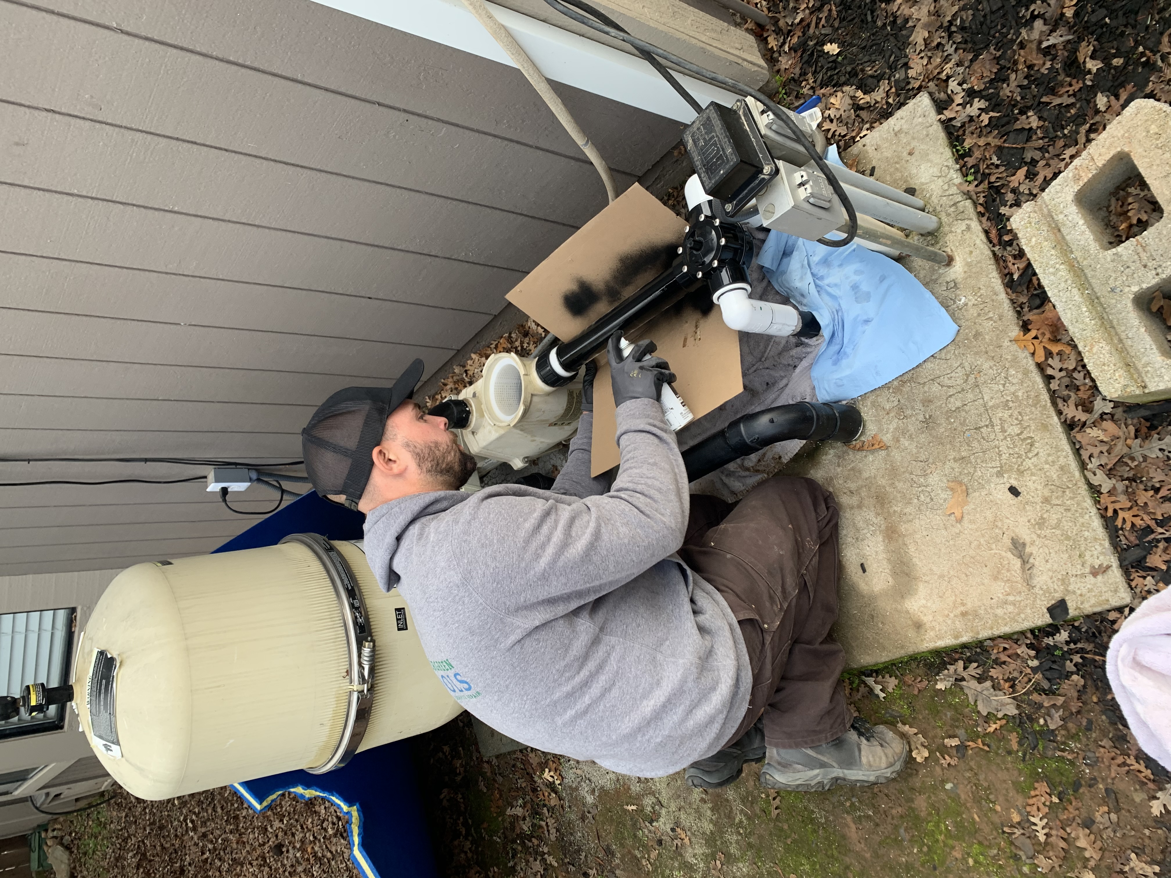 Woody's Pools technician brushing a clean residential pool